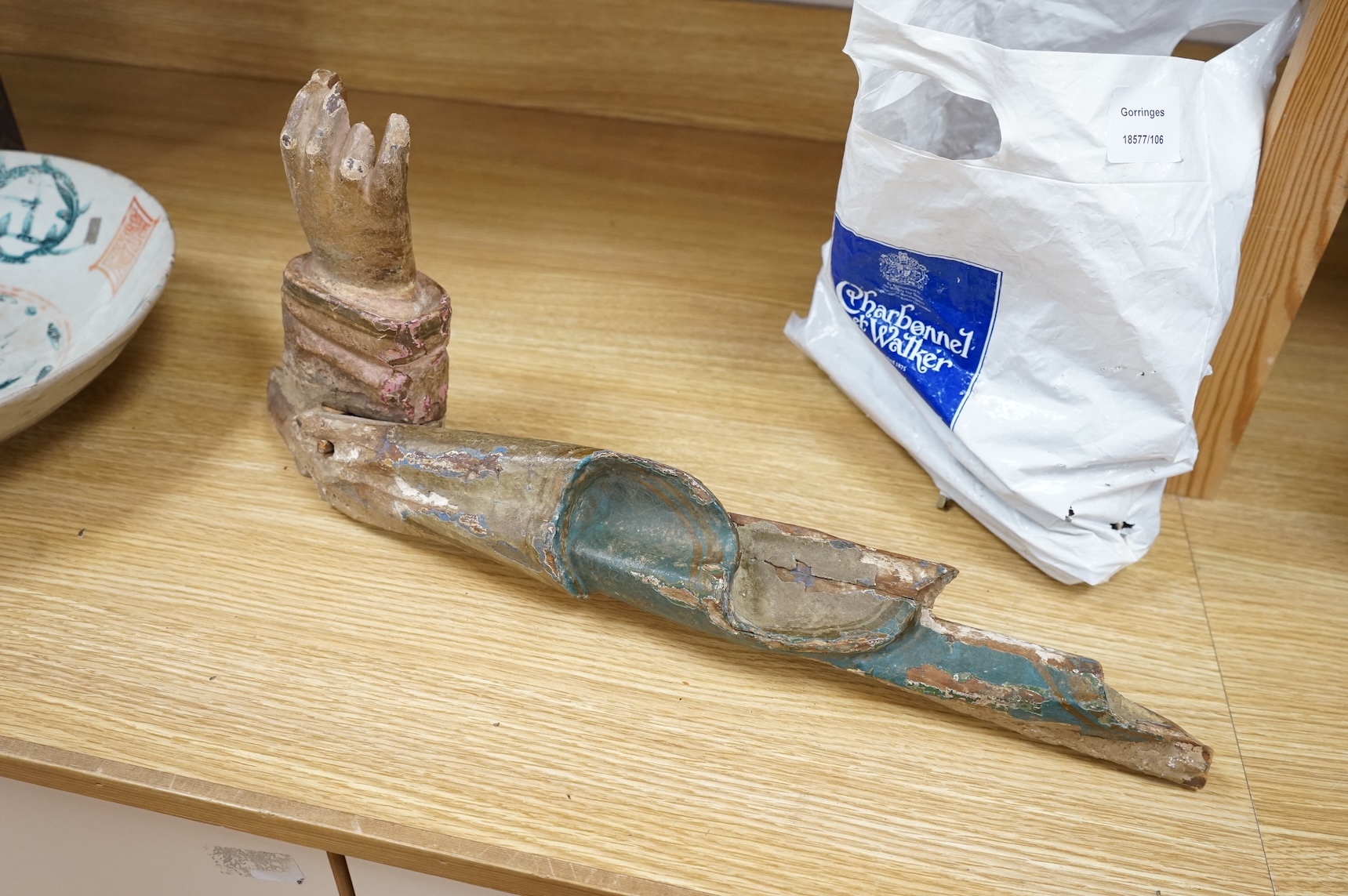 An 18th/19th century painted wood model of a Saint's arm, 56cm